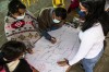 A view from above of people of the Kisgó reservation and Hub colleagues working together to co-create maps of their territory thumbnail